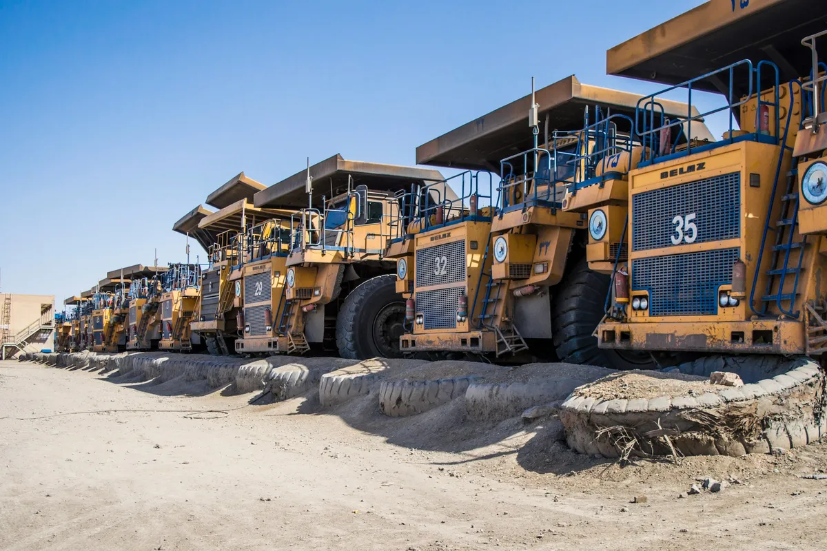 Mining haul trucks lined up at a mine site - heavy industry automation